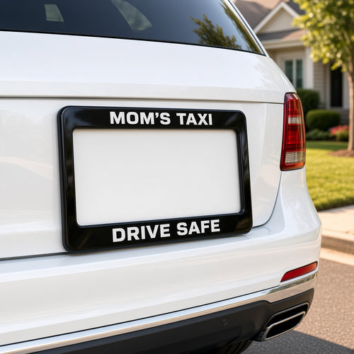 Custom MOM'S TAXI DRIVE SAFE license plate frame mounted on white SUV